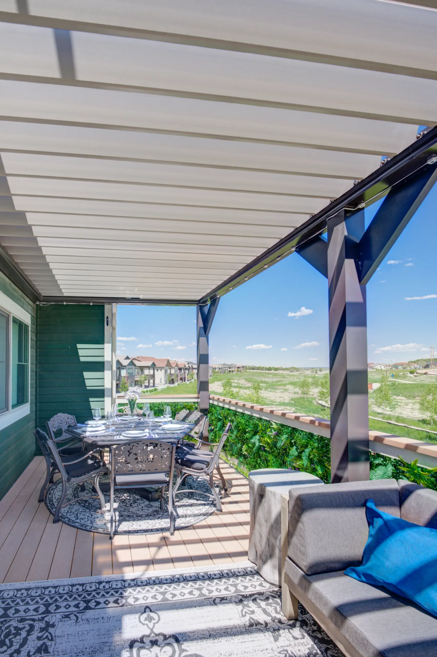 Composite deck covered with an attached louvered pergola