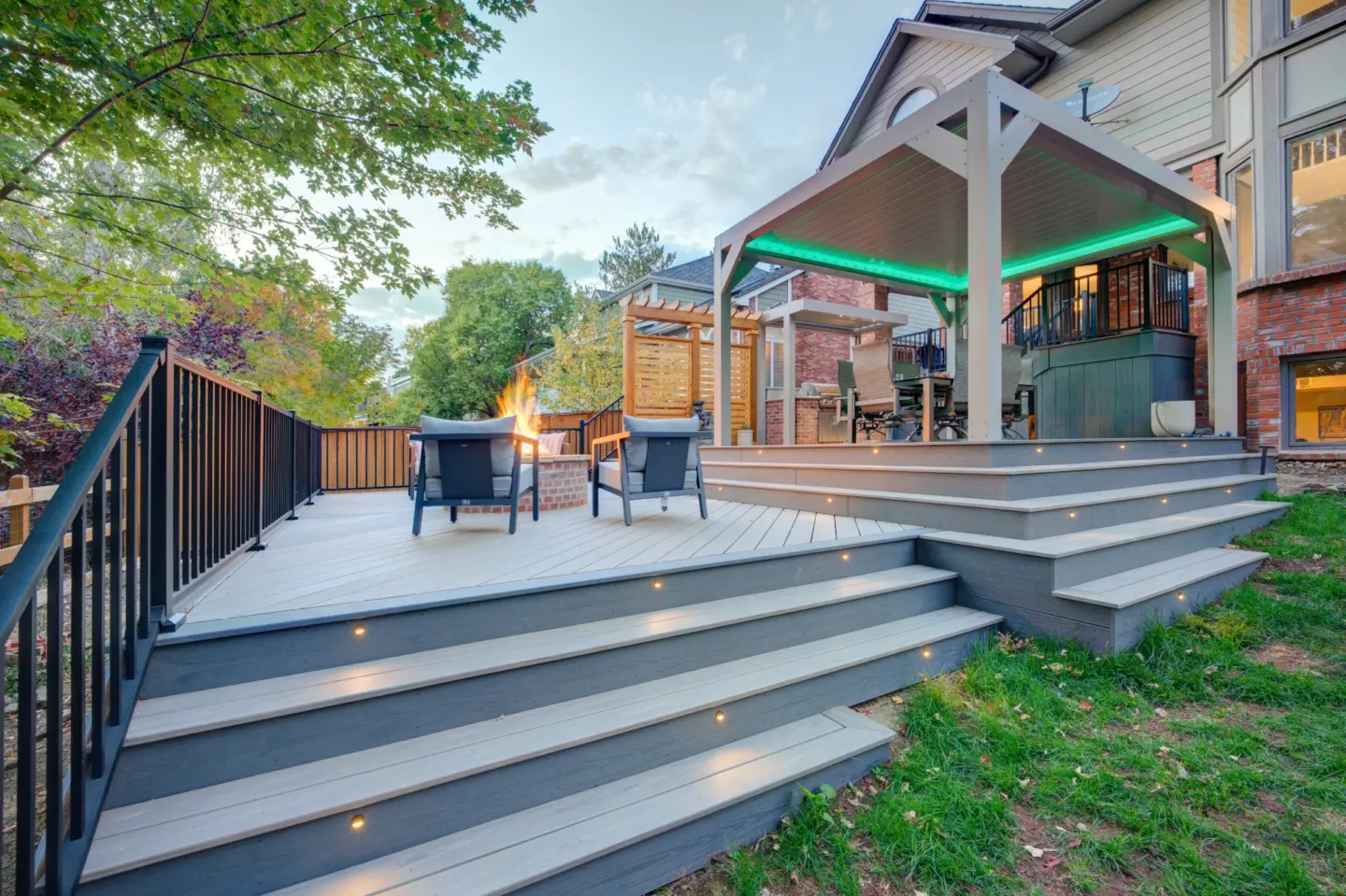 Gray PVC Deck with steps lights brown aluminum railing and dinning table