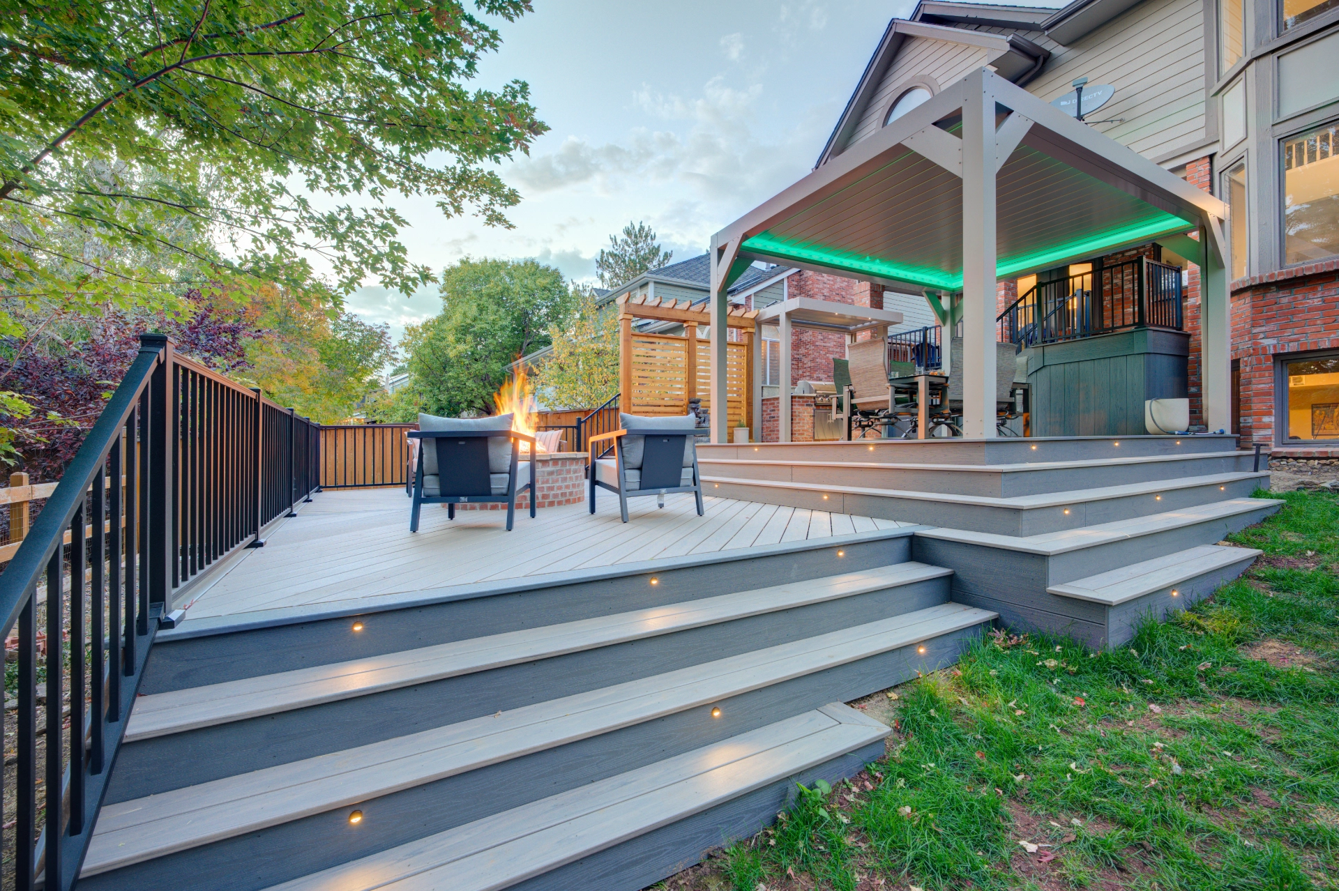 Gray PVC Deck with steps lights brown aluminum railing and dinning table